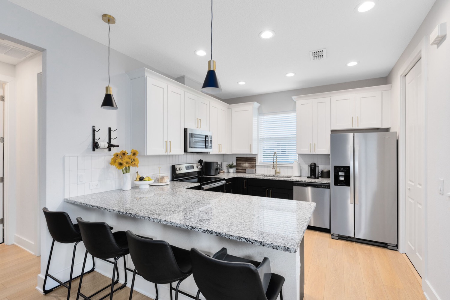 ADU interior kitchen with granite countertop and barstools by Talbot Custom Homes in Orlando, FL