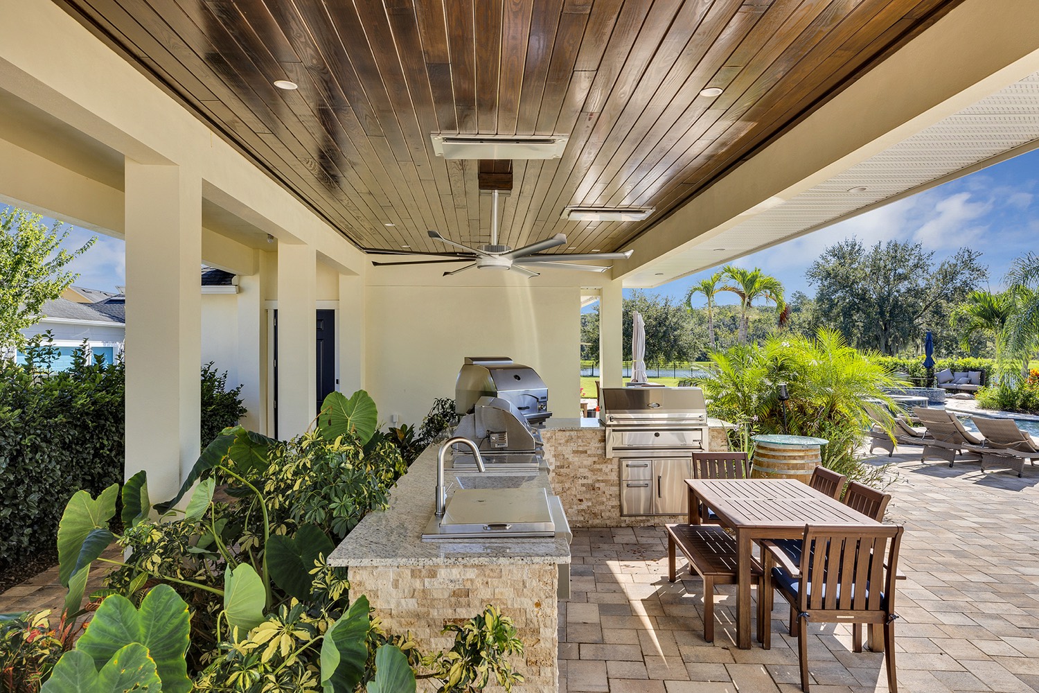 Outdoor kitchen with ceiling fan by Talbot Custom Homes in Central Florida