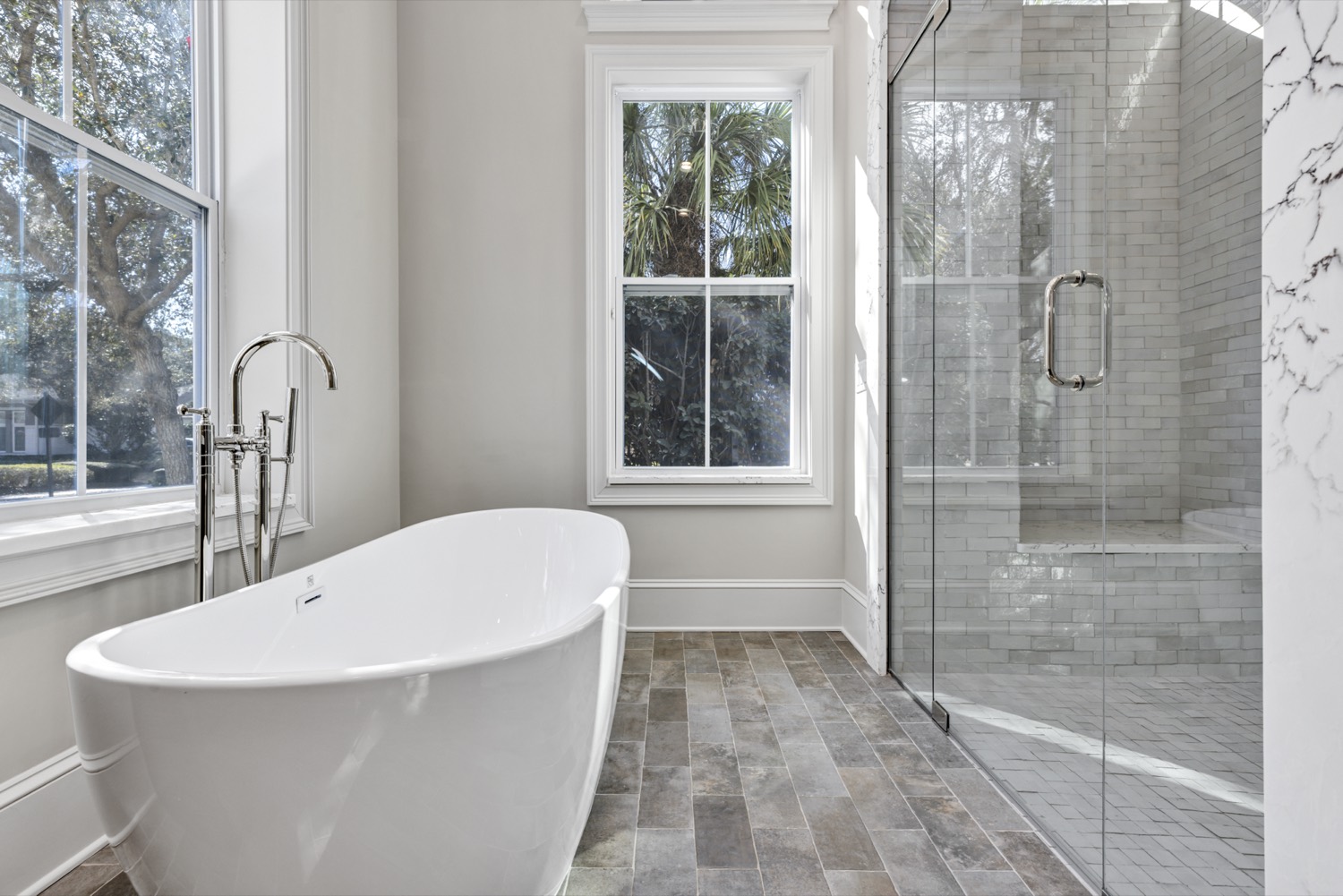 Custom primary bathroom with tile and natural light by Talbot Custom Homes in Central Florida