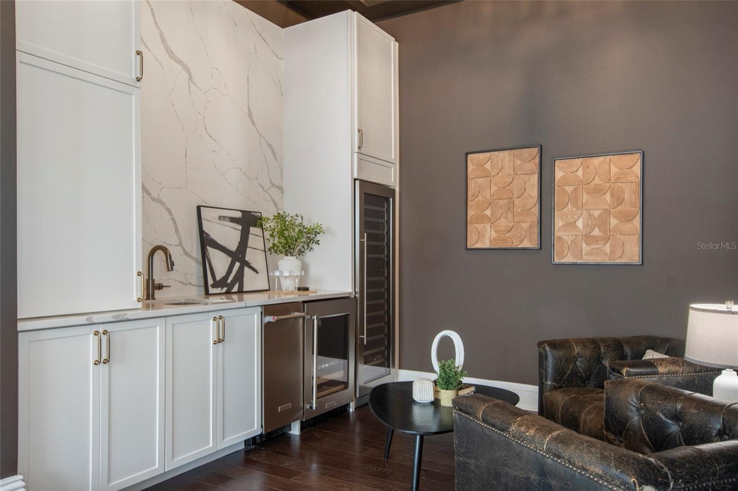 Interior wine room with gray wall and white cabinetry by Talbot Custom Homes in Orlando, FL